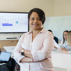 Master of Pharmaceutical Industry Practice student standing confidently in boardroom setting, presenting data